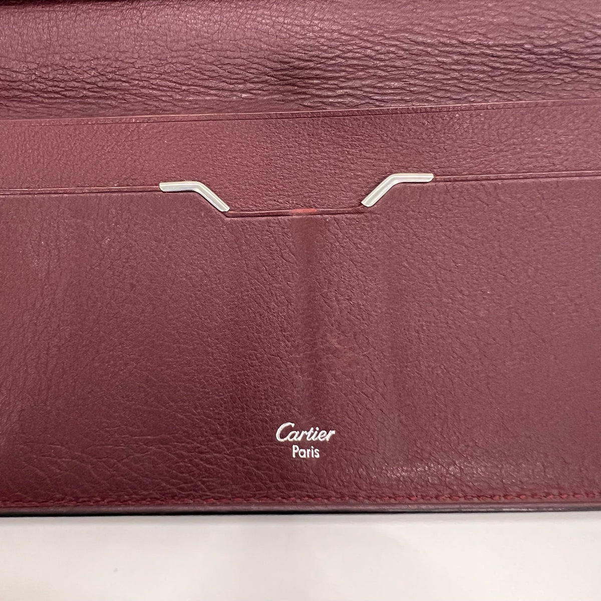 CARTIER Portadocumenti "Must de Cartier" pelle nera ed interno bordeaux