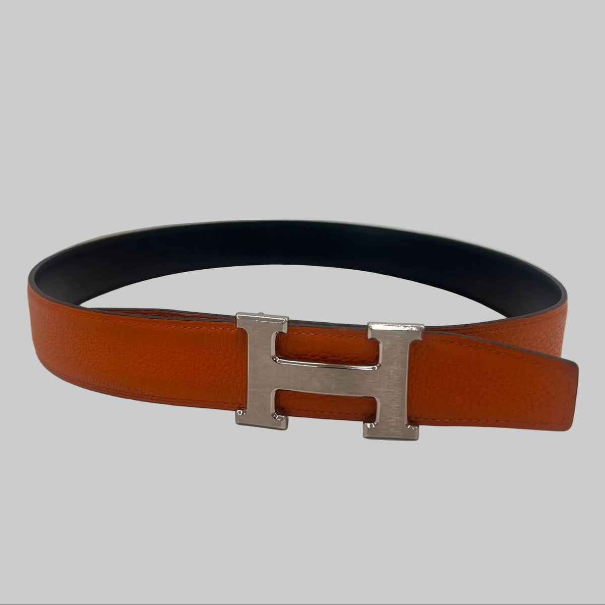 HERMES Cintura "Iconic Classic" reversibile nera e arancione con fibbia H argento
