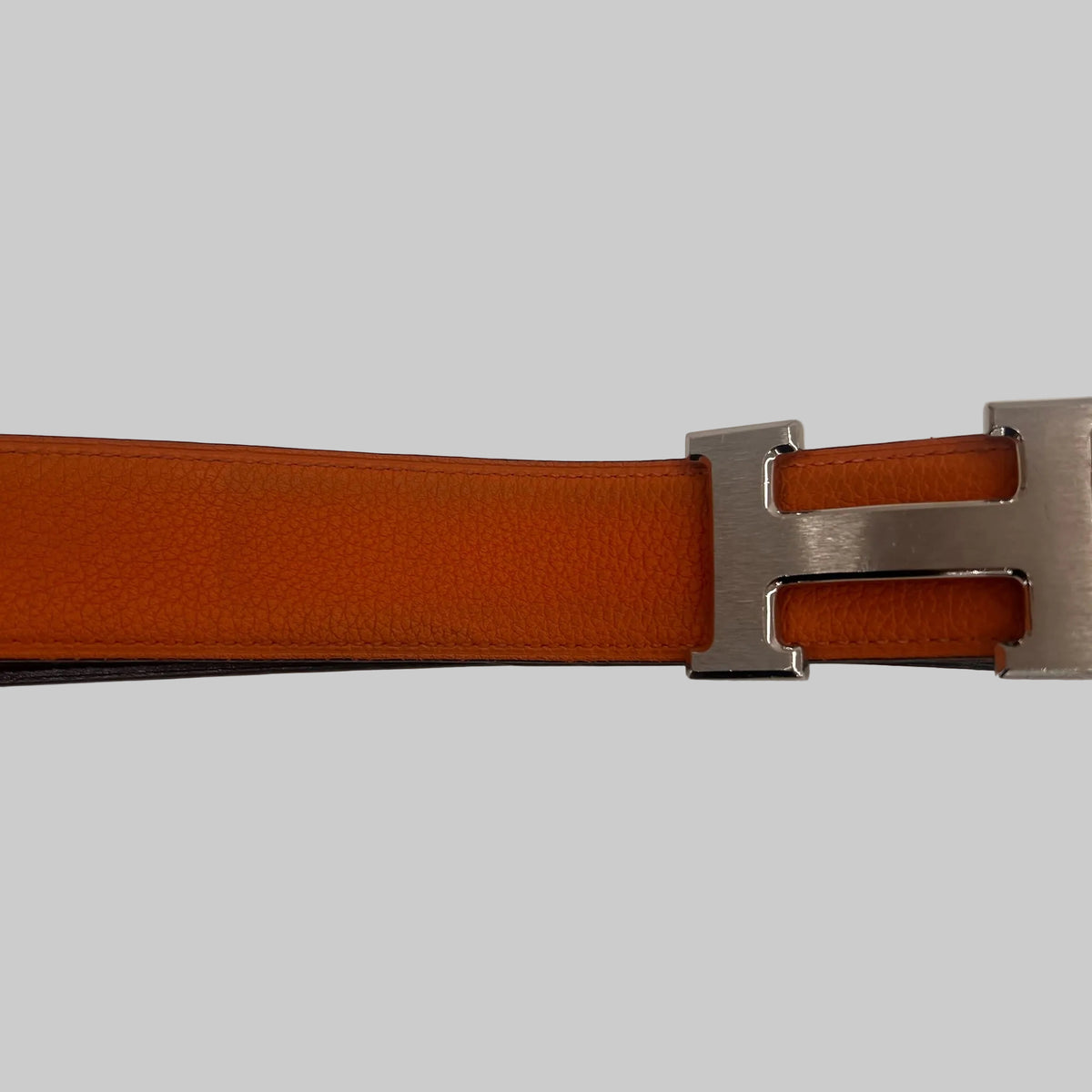 HERMES Cintura "Iconic Classic" reversibile nera e arancione con fibbia H argento