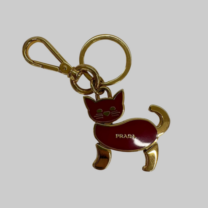 PRADA Ciondolo charms portachiavi dorato con gatto rosso