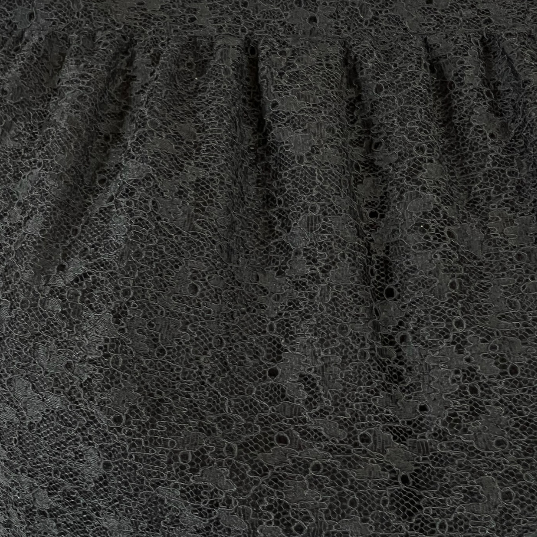 SAINT LAURENT Abito nero in pizzo con borchie
